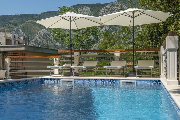 Heated swimming pool and sun lounges