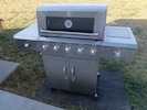 New 5 burner gas grill with side burner.
