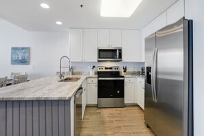 Fully stocked kitchen including spice rack and a compliment of small appliances
