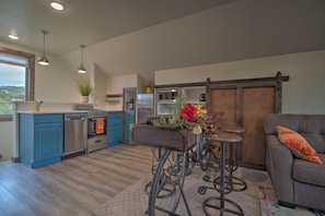 Kitchen showing sliding barn door open to pantry