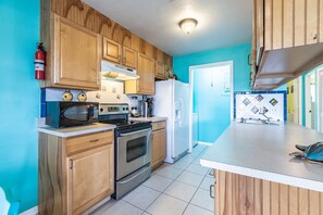 The nicely equipped kitchen comes fully stocked with everything you need to prepare and cook meals.