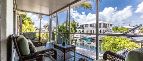 Enjoy a soothing canal front view from the screened porch, providing a perfect setting for relaxation.