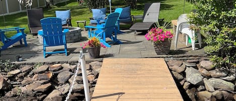 Lake front slate patio with fire pit.