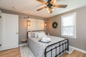 Primary bedroom with fun lighting, lots of towels & bedding supplied.