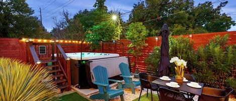 The front yard boasts w/all-year-round swim spa, dining setup & Cornhole game.