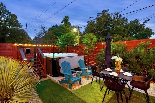 The front yard boasts w/all-year-round swim spa, dining setup & Cornhole game.