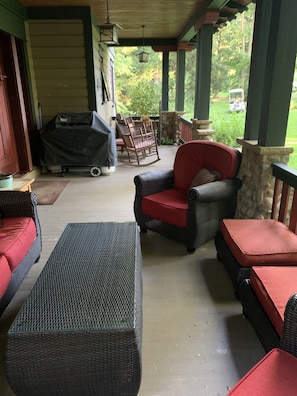 Additional view of porch with grill and seating area.
