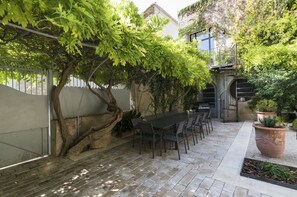 Jardin aménagé avec son espace repas, barbecue Campinggaz.