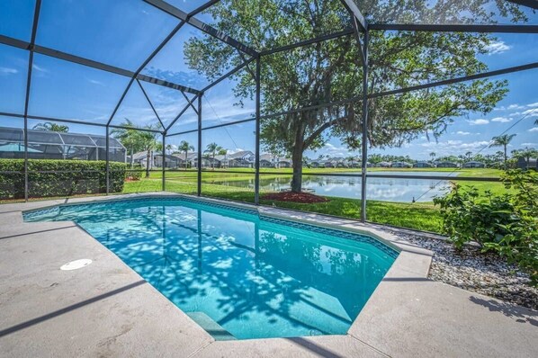 Private pool on back patio submerged in nature with a lake view!