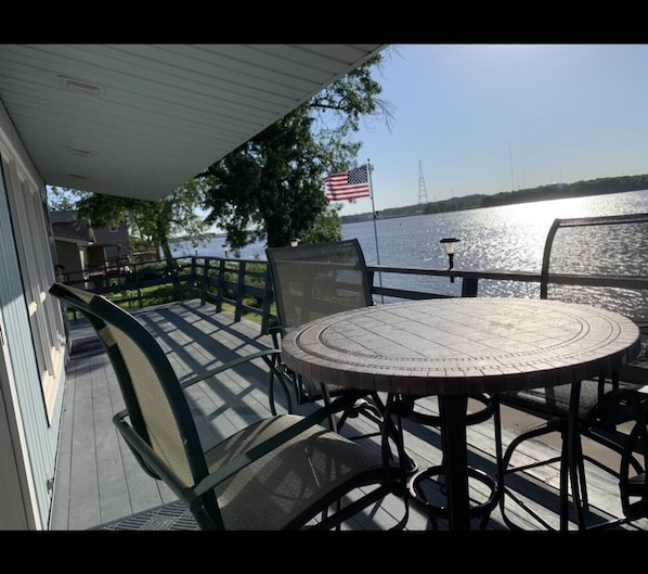 Balcony with table and 4 high chairs.