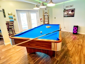 Game on: pool table & PartyBox speaker with Bluetooth connect for lake vibes.