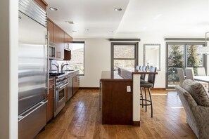 Fully equipped kitchen with kitchen island and hardwood floors throughout