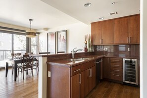 Cherry wood cabinets and red granite in the kitchen, dedicated wine fridge