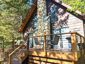 Enjoy the deck at Into the Woods Cabin