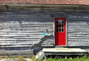 side of main cabin, large deck on other two sides