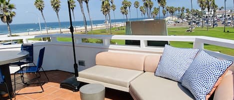 Outdoor couches and dining overlooking the ocean. Walk to everything in MB