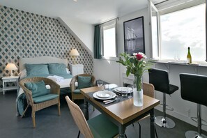 Studio - living room with dining area and sleeping area