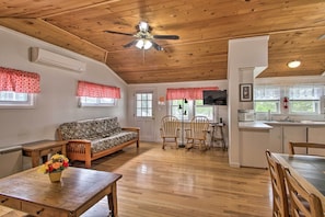 This open concept living area with cathedral ceilings feels extra spacious.
