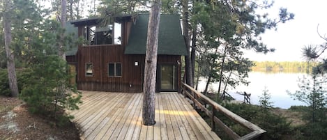 Cabin, dock, bay; Deck built around the trees and rocks