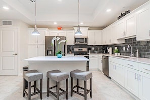 Kitchen with Large Island and 3 Barstools.