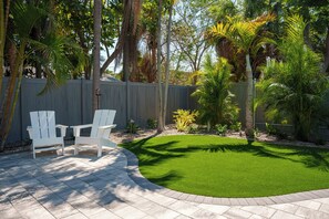 Unwind amongst the mature palm trees in our newly remodeled backyard.