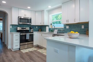 Delight in our well appointed kitchen with breakfast bar and dining nook.