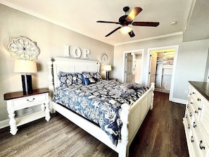 Master bedroom with king-size bed,  ceiling fan, and balcony access.