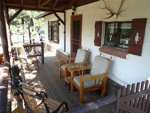 Front porch with 2 rocking chairs and 2 large cushioned chairs