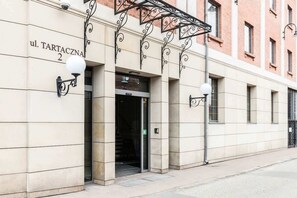 The exterior of the building with a polished, classic design. The entrance is marked with a clean sign and elegant street details.