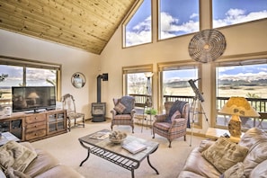 Vaulted ceilings and expansive windows offer an inviting interior.