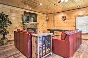 This living area provides games, a fireplace, and a TV.