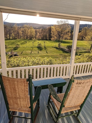 Two of the many rocking chairs on the back deck looking out over the field.