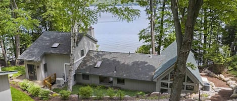 FIRST IMPRESSION: STUNNING VIEW of house and lake as you approach from the road