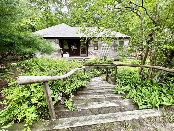 view of house from circular driveway at top of stairs