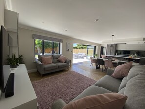 Open plan area with bi-fold doors opening onto patio and garden