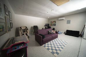Game / Exercise room with Queen size pull out bed, Xbox, Ms Pac Man, massage chair, gravity chair, Peloton bike, weights and exercise ball