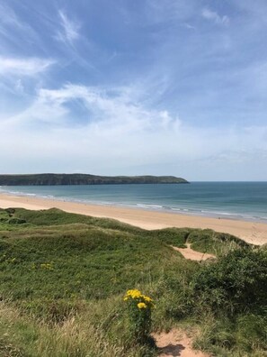 this beautiful beach is a 10 minute down hill walk away .
