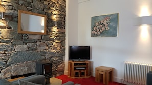 Living room with 32" TV, log burner.