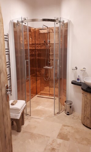 Shower room with hand beaten copper shower surround.
