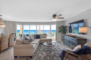 Living room with new sectional sofa, large flat screen tv, new console.