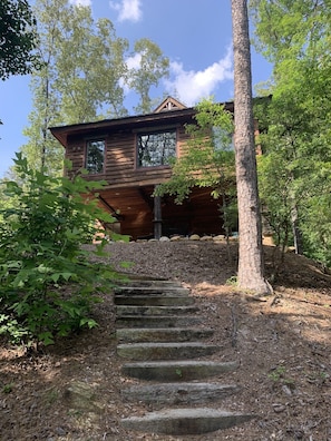 As viewed from the lake side. Covered patio for gathering and outdoor dining.