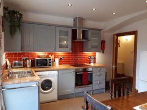 Kitchen dining area looking through to hallway.