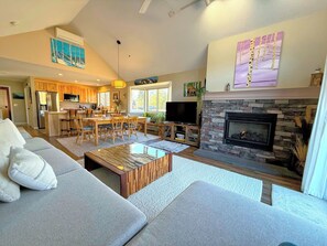 Dining and living areas with gas fireplace and TV