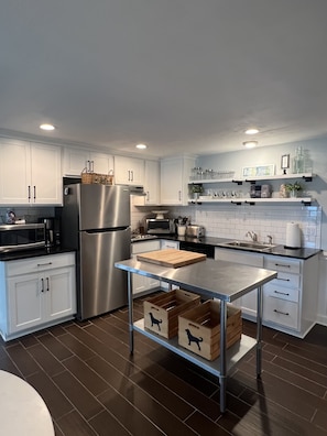 Open Kitchen with Granite Countertops and Stainless Steel Appliances.