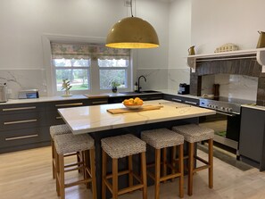 Kitchen - features an oven, dishwasher, microwave, bread maker & coffee machine.