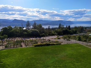 A view during the day capturing the garden and view of Lake Okanagan