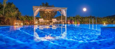 Dive into moonlit bliss at our pool, a celestial escape awaits