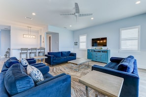 Relax in the Spacious Coastal Heaven Living Room - There’s space to kick back and plenty of seats for you and your guests in this large, comfortable living room.