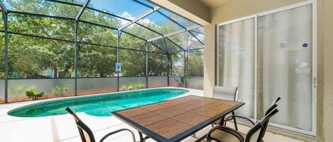 A beautiful private pool and outdoor dining area on back lanai.