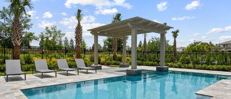 Pool with Waterfall feature - Large Custom Pool with poolside seating and Spa.  Exit out the back gate to the playground or walking path